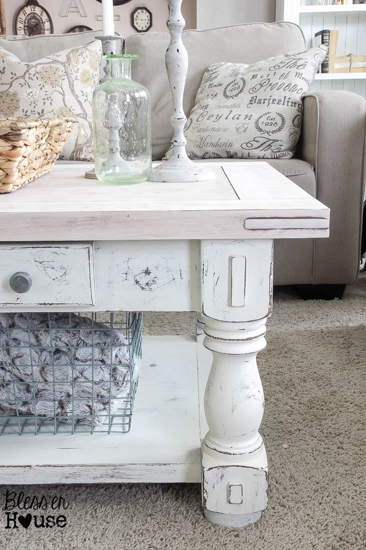 The newly transformed chippy white and lime waxed coffee table styled in a living room, featuring decor elements like books and a plant, creating a cozy farmhouse atmosphere.