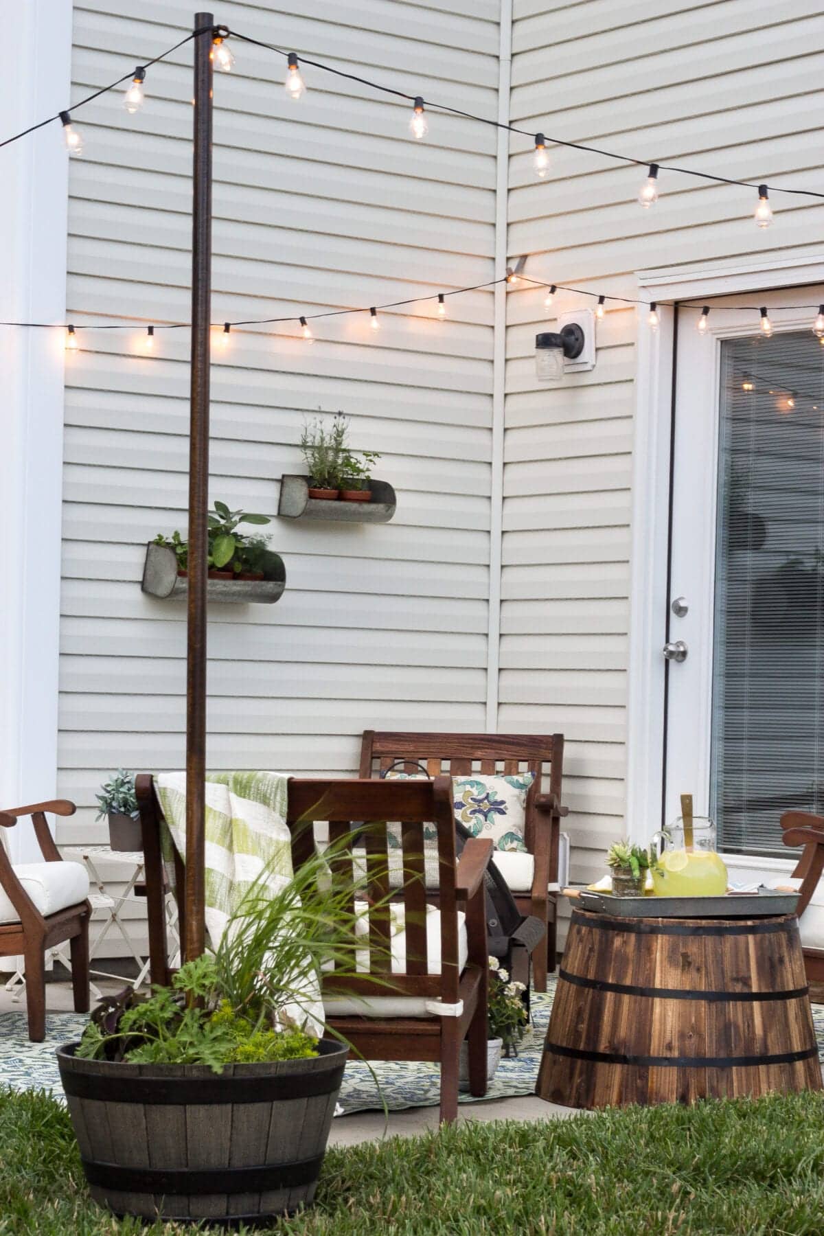 string lights around a patio from siding clips and planter posts