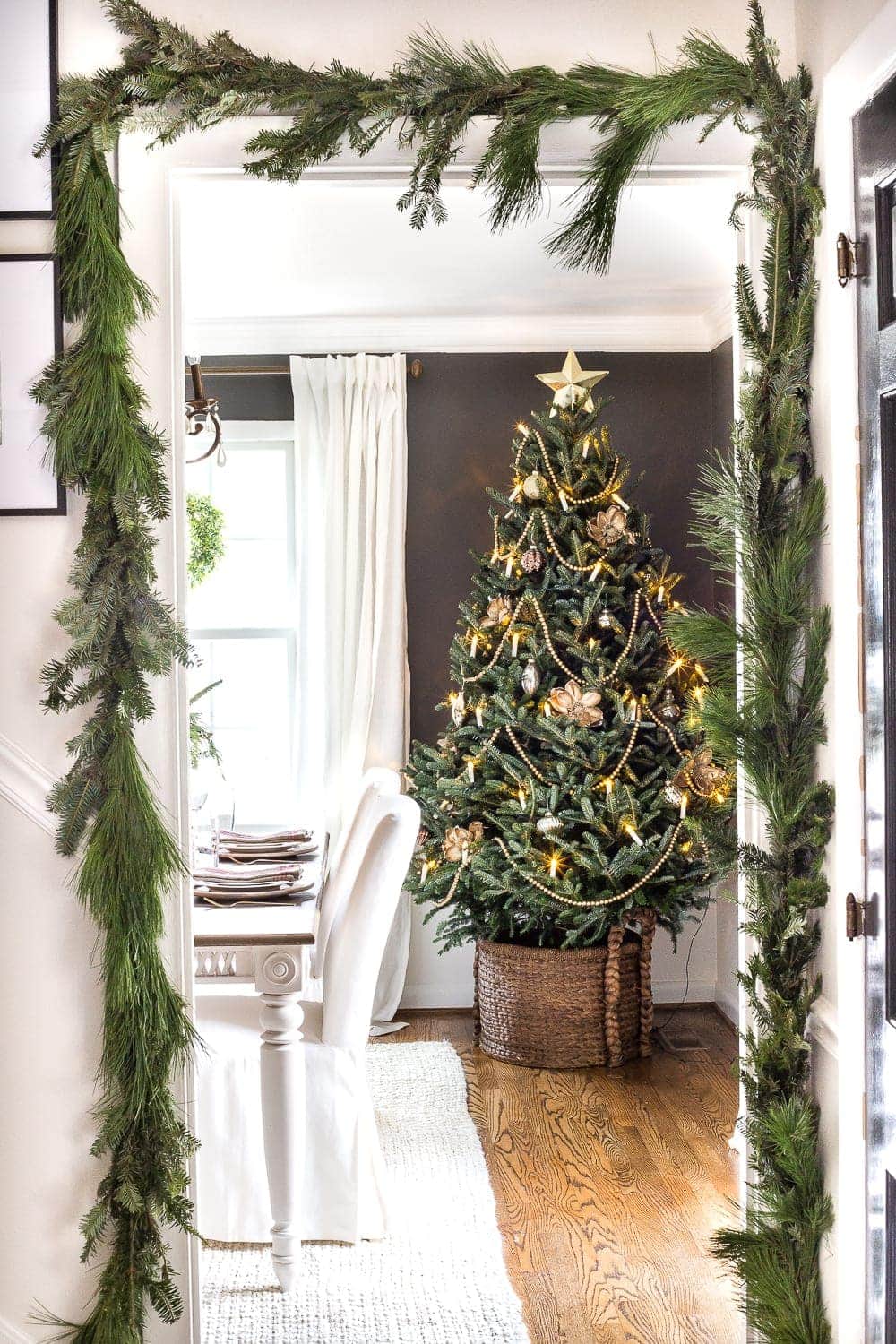 real christmas garland around door frame with real christmas tree