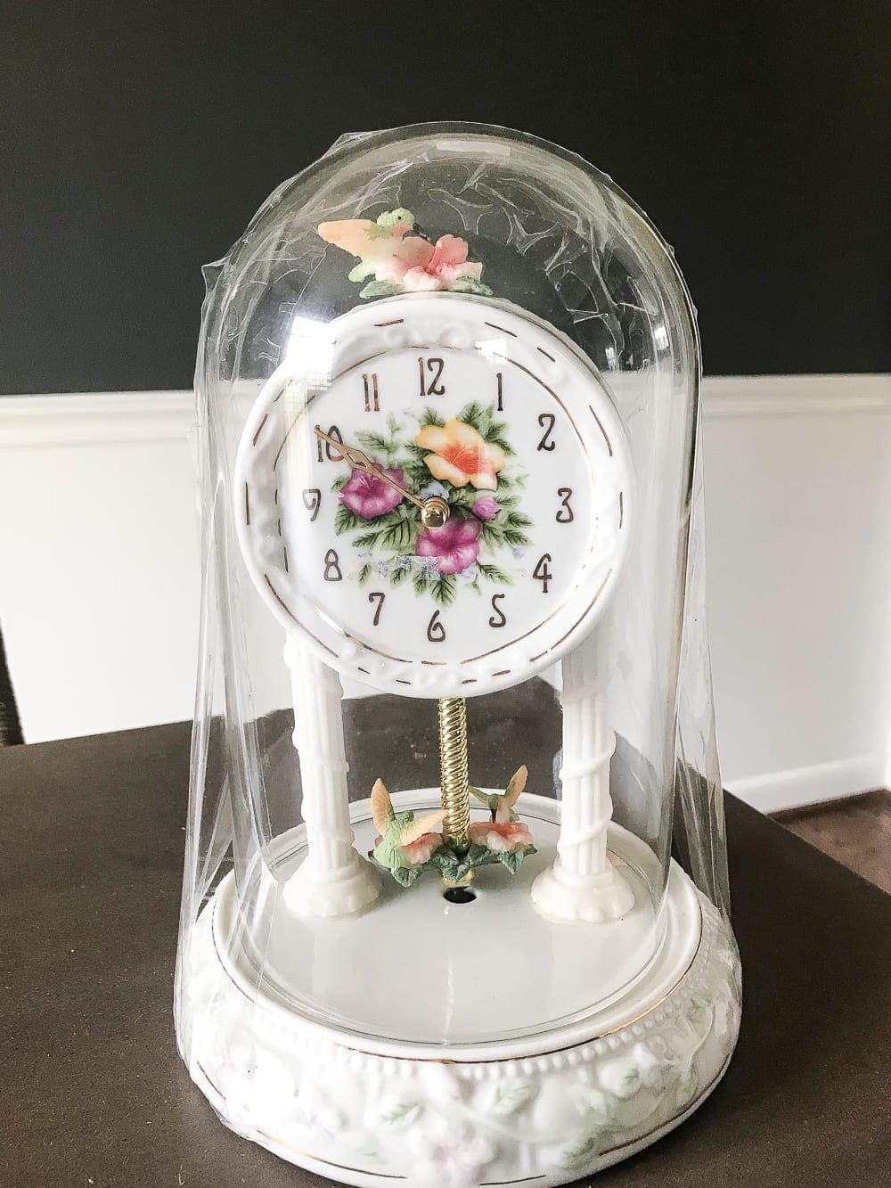 How to turn a cheap, thrifted dome clock into a Victorian style butterfly terrarium cloche with free printables to make your own paper butterflies for spring. #springdecor #thrifteddecor #cloche #springvignette #girlydecor #butterflies 