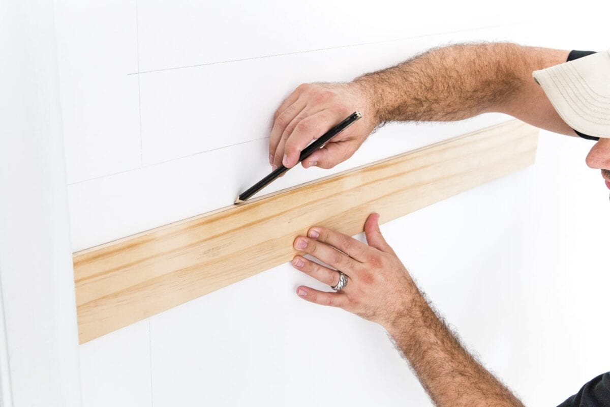 Use a 3/8" x 4" board as a spacer to mark picture frame molding