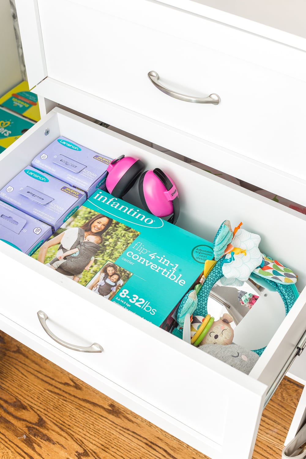 Nursery closet organization with shelving and built-in drawers for baby essentials