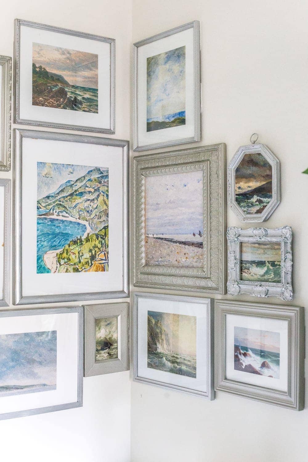 thrifted gallery wall with coastal art