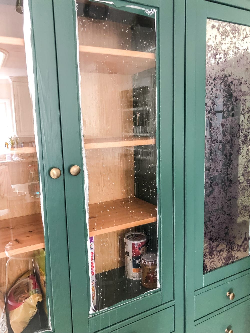 glass front cabinet sprayed with water 