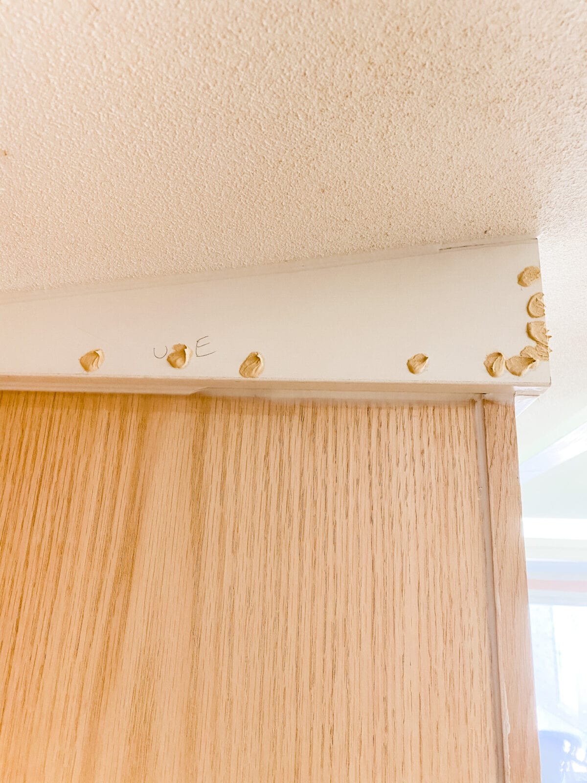 A step-by-step tutorial to build DIY built in cabinets and a window seat using inexpensive stock kitchen cabinets.