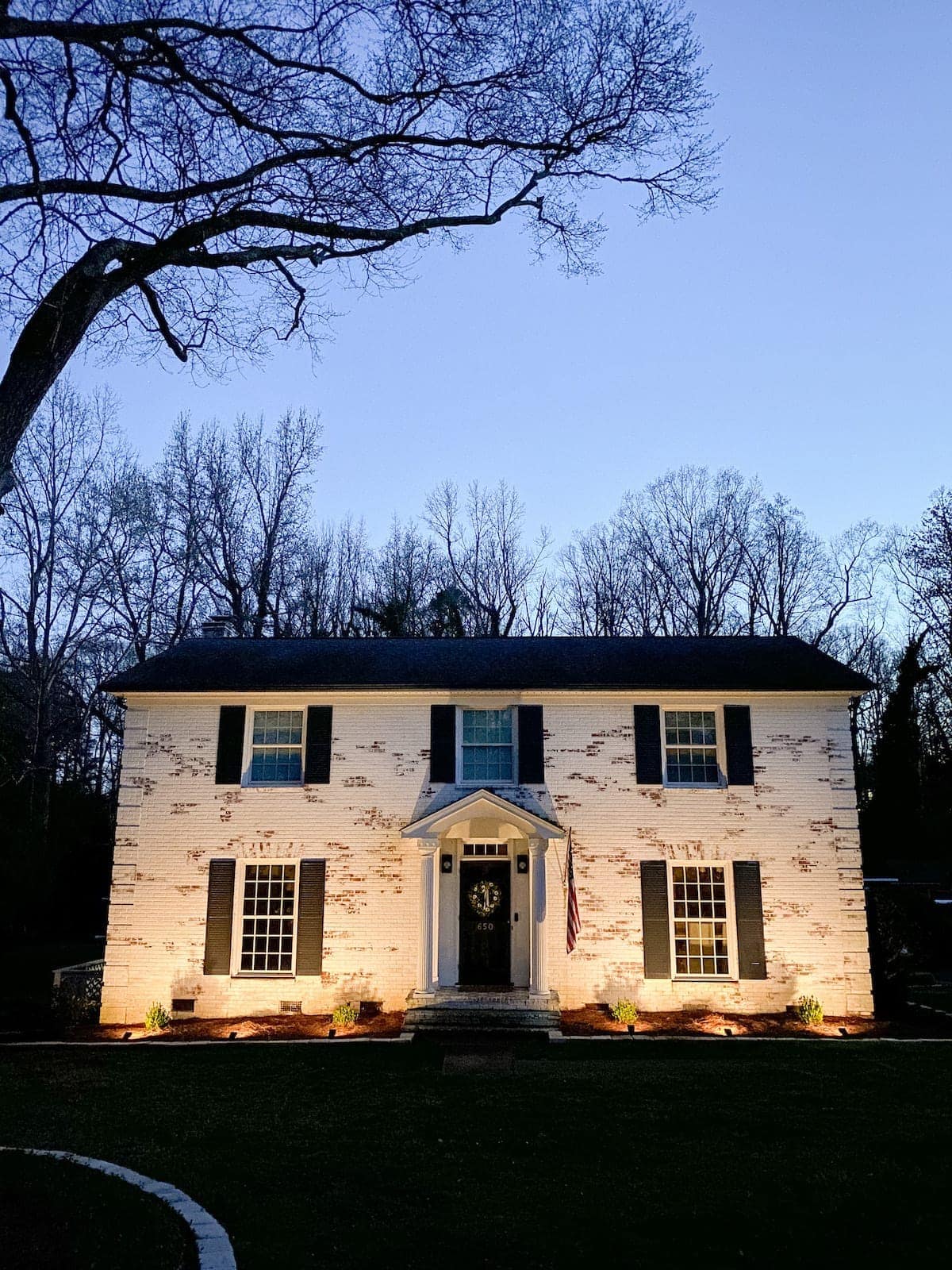 solar uplights shining on house