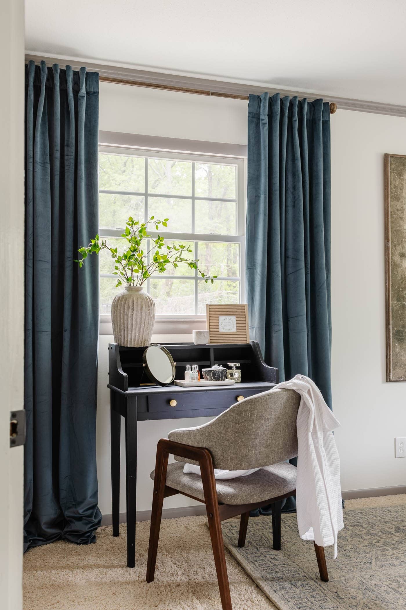 bedroom desk with blue curtains