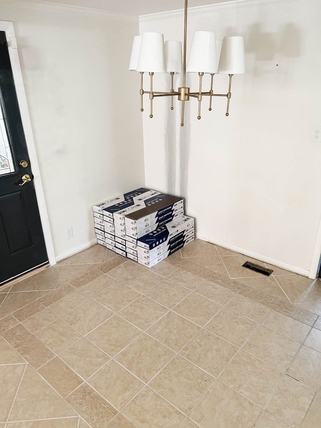 stack of LVP flooring on top of tile floor