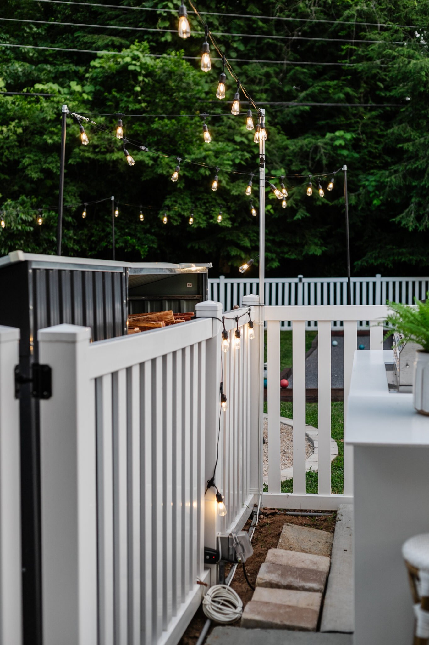 How to Hang Outdoor String Lights Anywhere in a Backyard Bless'er House