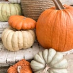 realistic fake pumpkins on limewashed brick porch steps