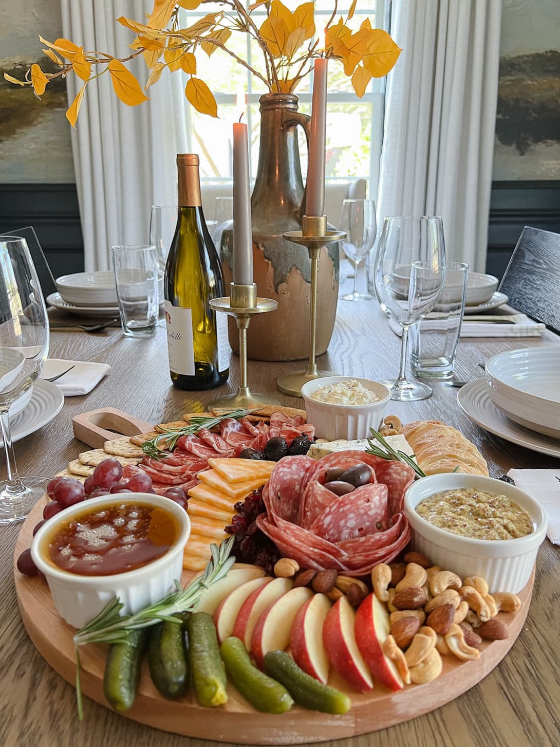 basic charcuterie board with cured meat, cheese, fruit, nuts, crackers, and dips