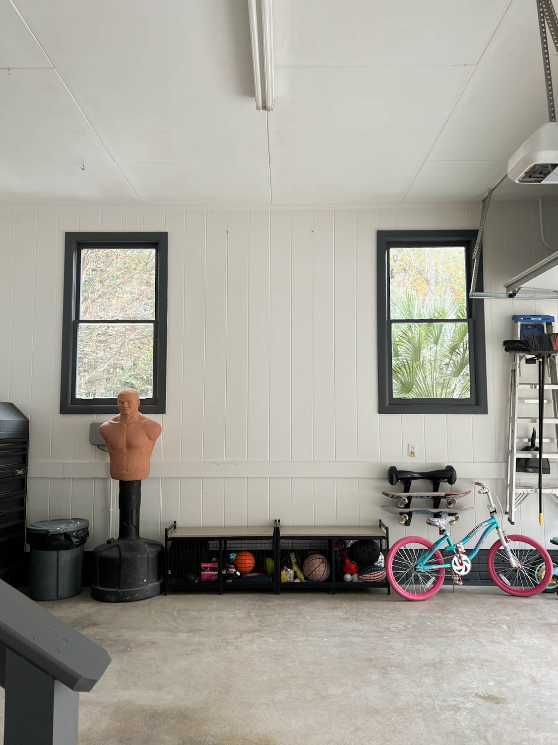 garage makeover after with white walls and black trim