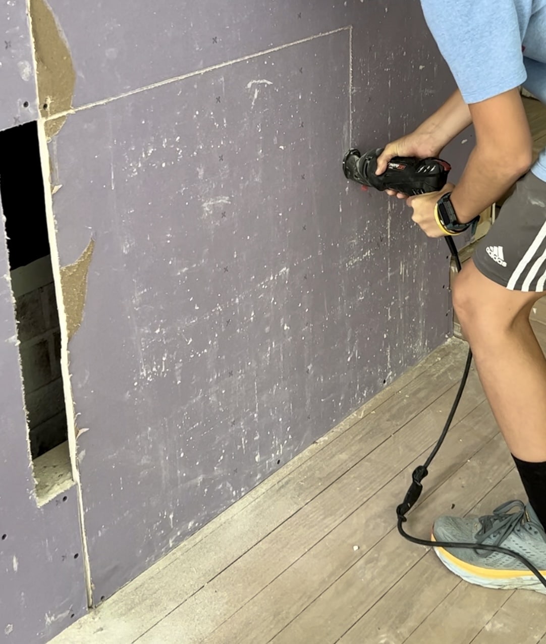 cutting out a fireplace insert using a rotary saw
