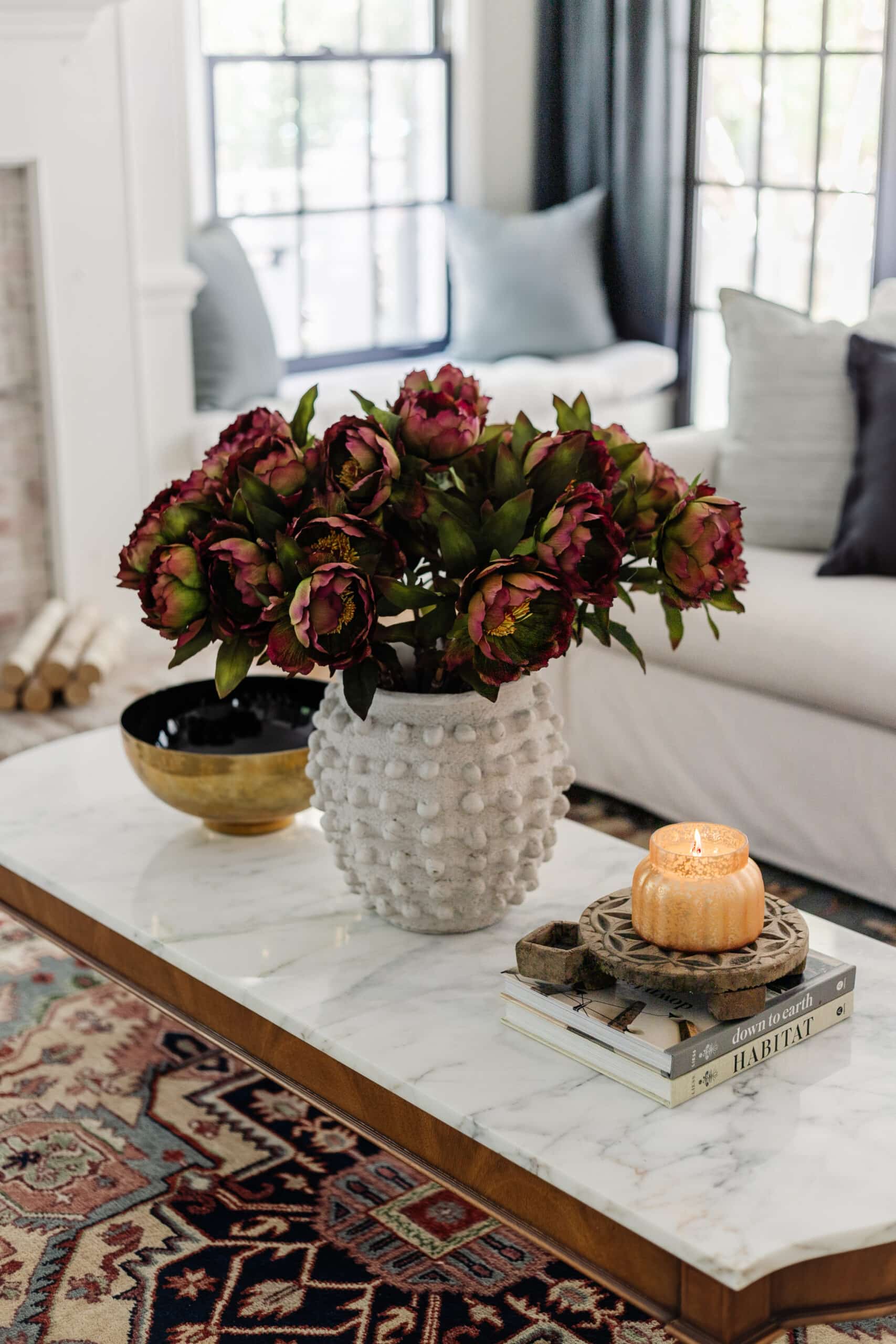 fall coffee table decor with vase of flowers and candle