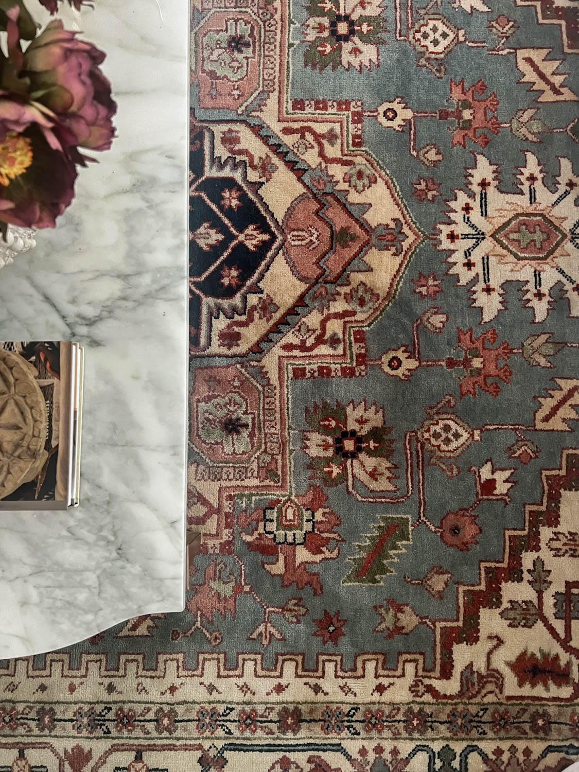 vintage rug with blue, green, burgundy, blush, and cream