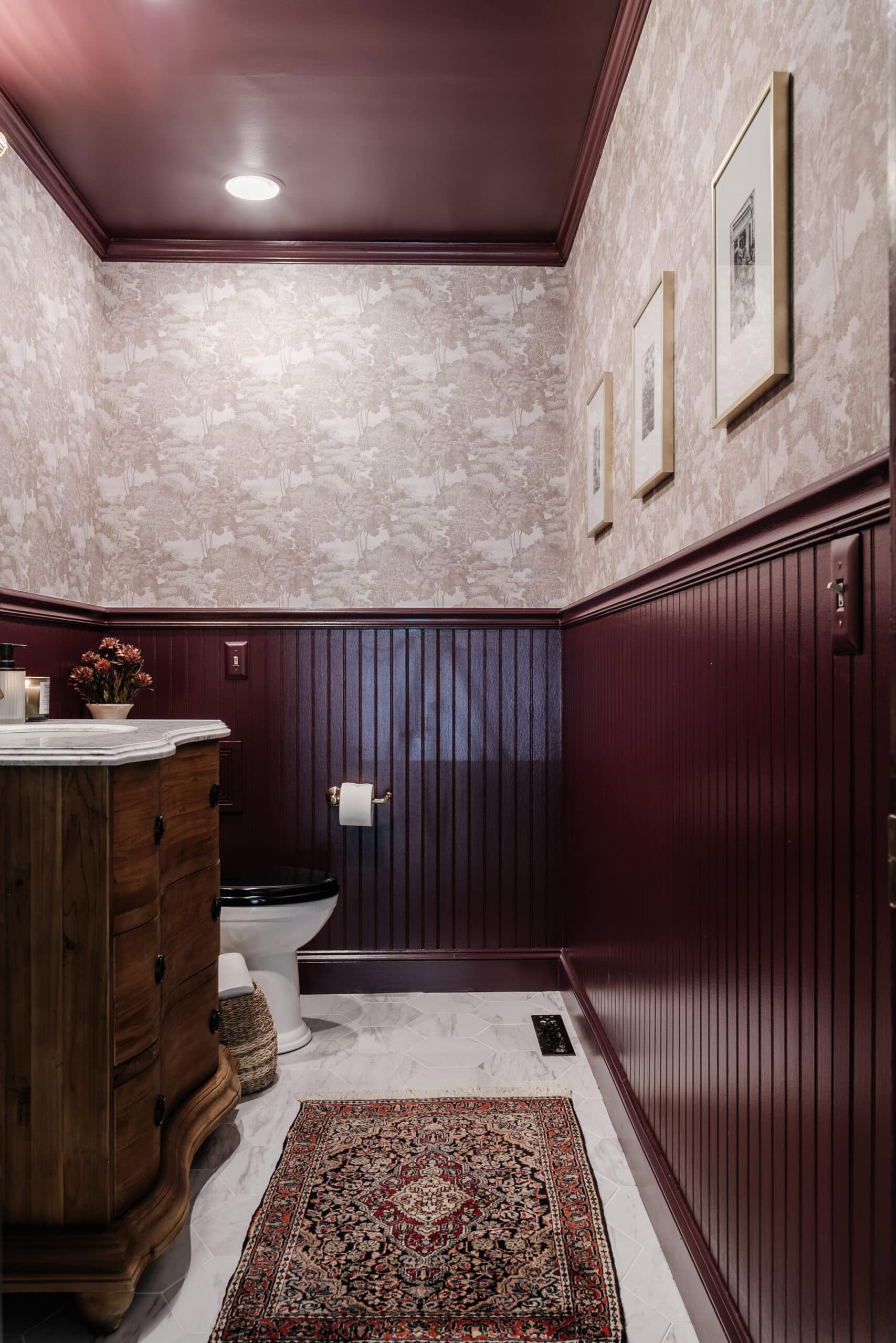 small windowless bathroom painted Farrow and Ball Brinjal with Rebel Walls Saint Sebastian wallpaper