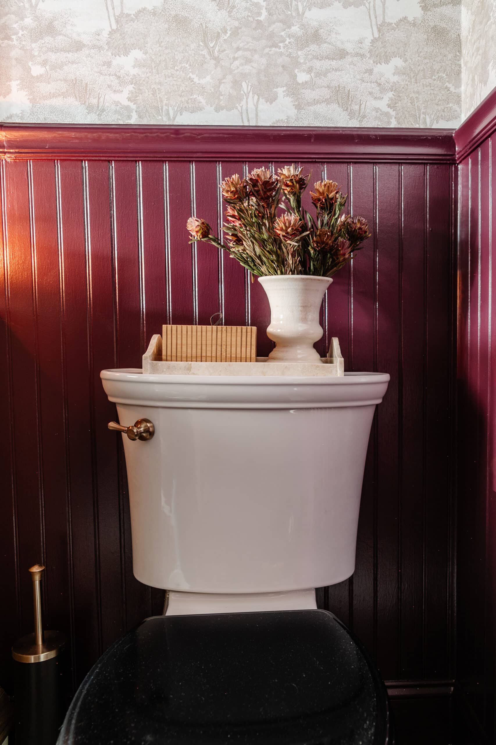 Vintage black toilet lid and back of toilet decor