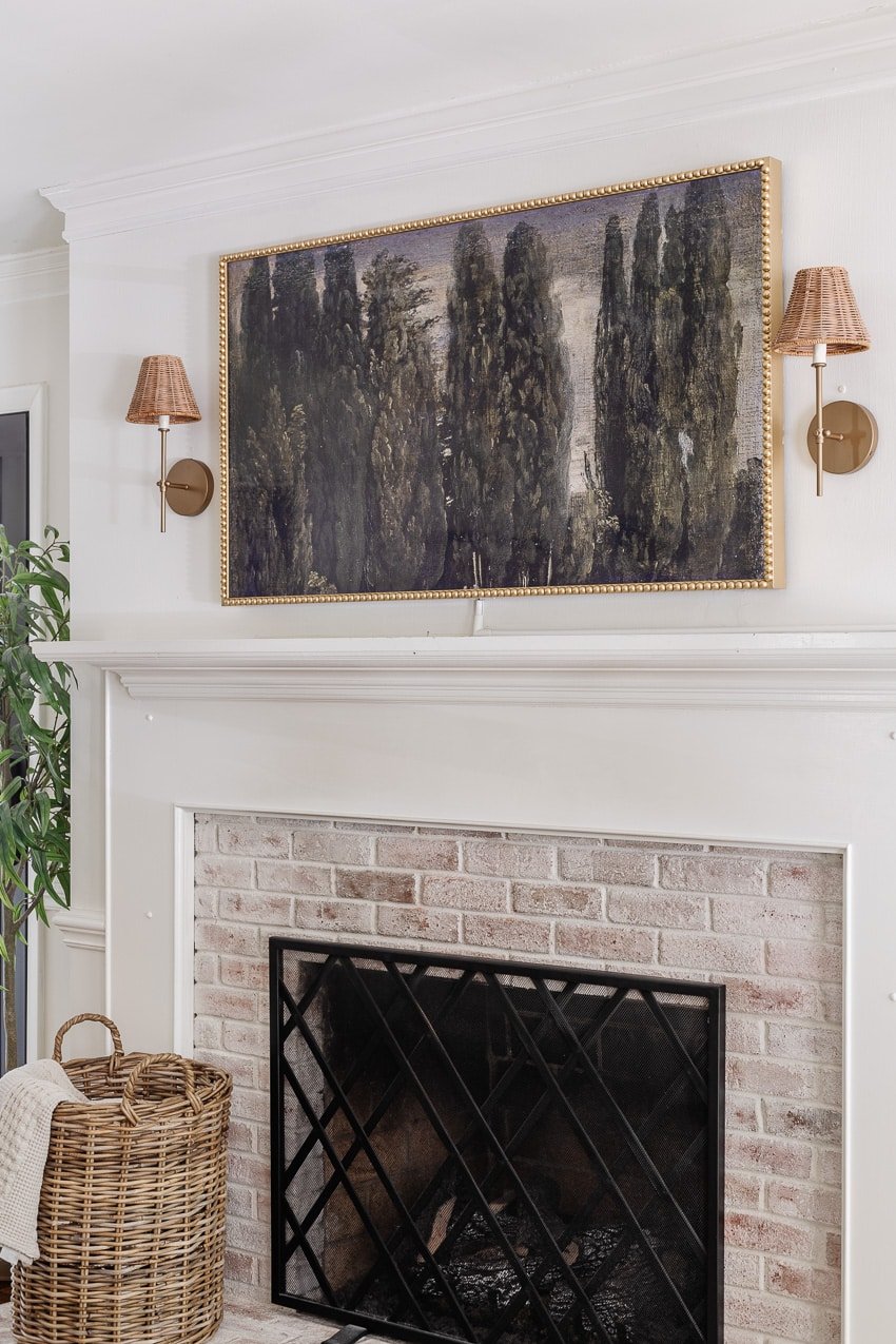 DIY bobbin frame on a Samsung frame TV + rattan sconces above a limewashed brick fireplace