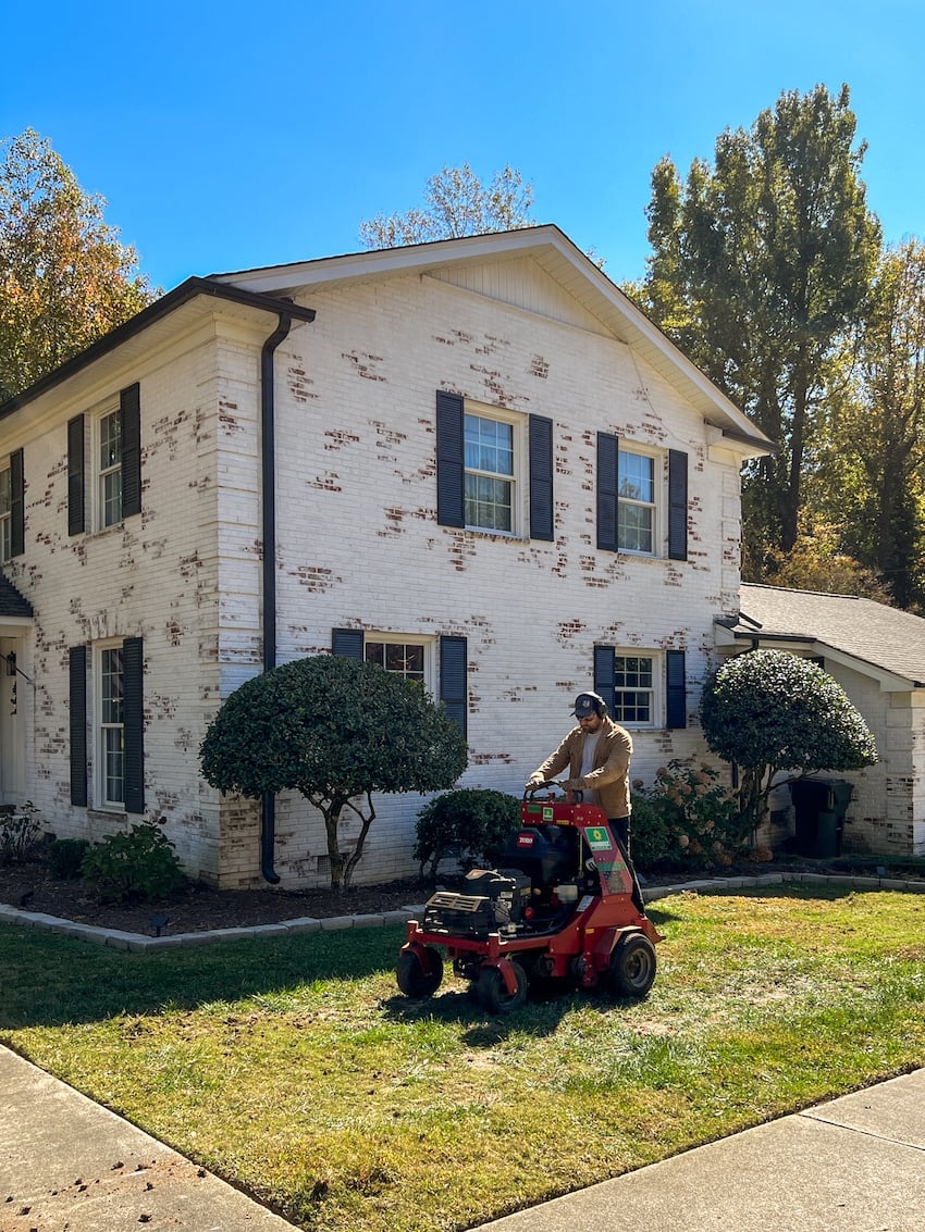 riding on an aerator on a lawn in the fall for planting grass seed