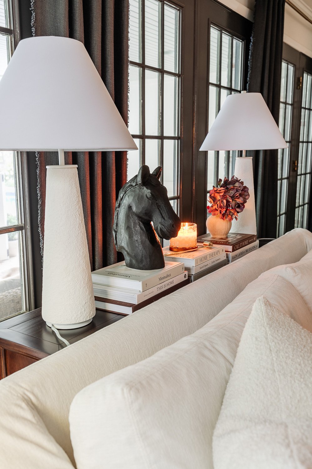 sofa table decor ideas behind a sofa using lamps, books, and candles