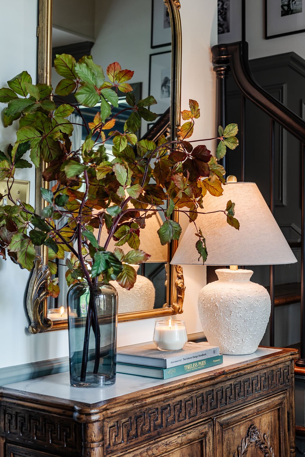 vase of tall fall stems on entryway table credenza