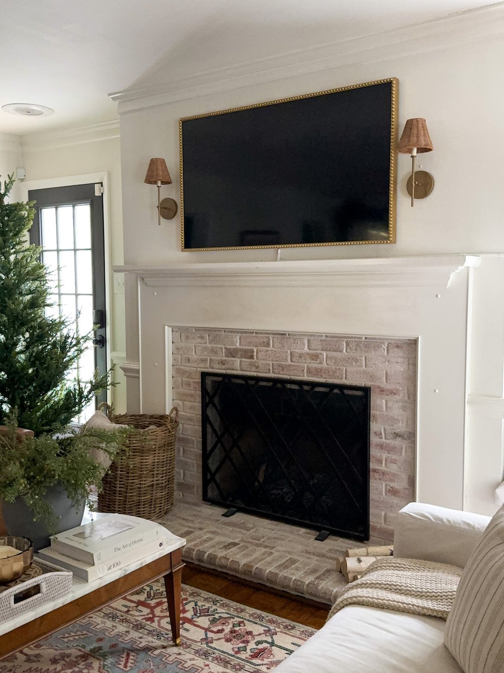 plain mantel with limewashed brick fireplace