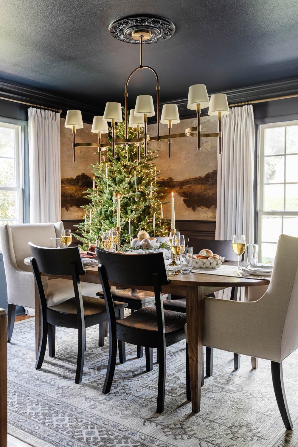 navy blue dining room decorated for Christmas with mural walls