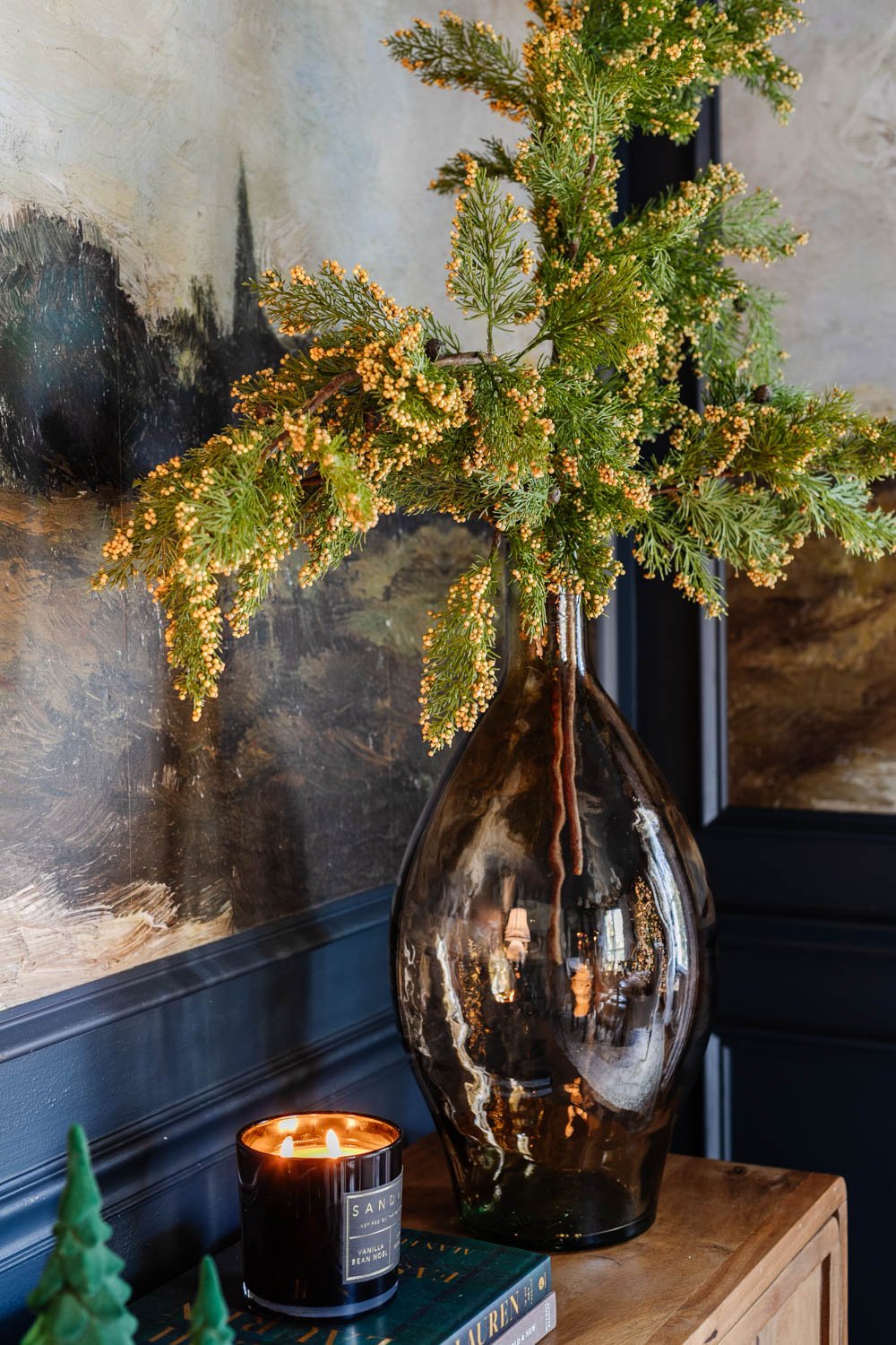 vase of Christmas greenery on dining room sideboard