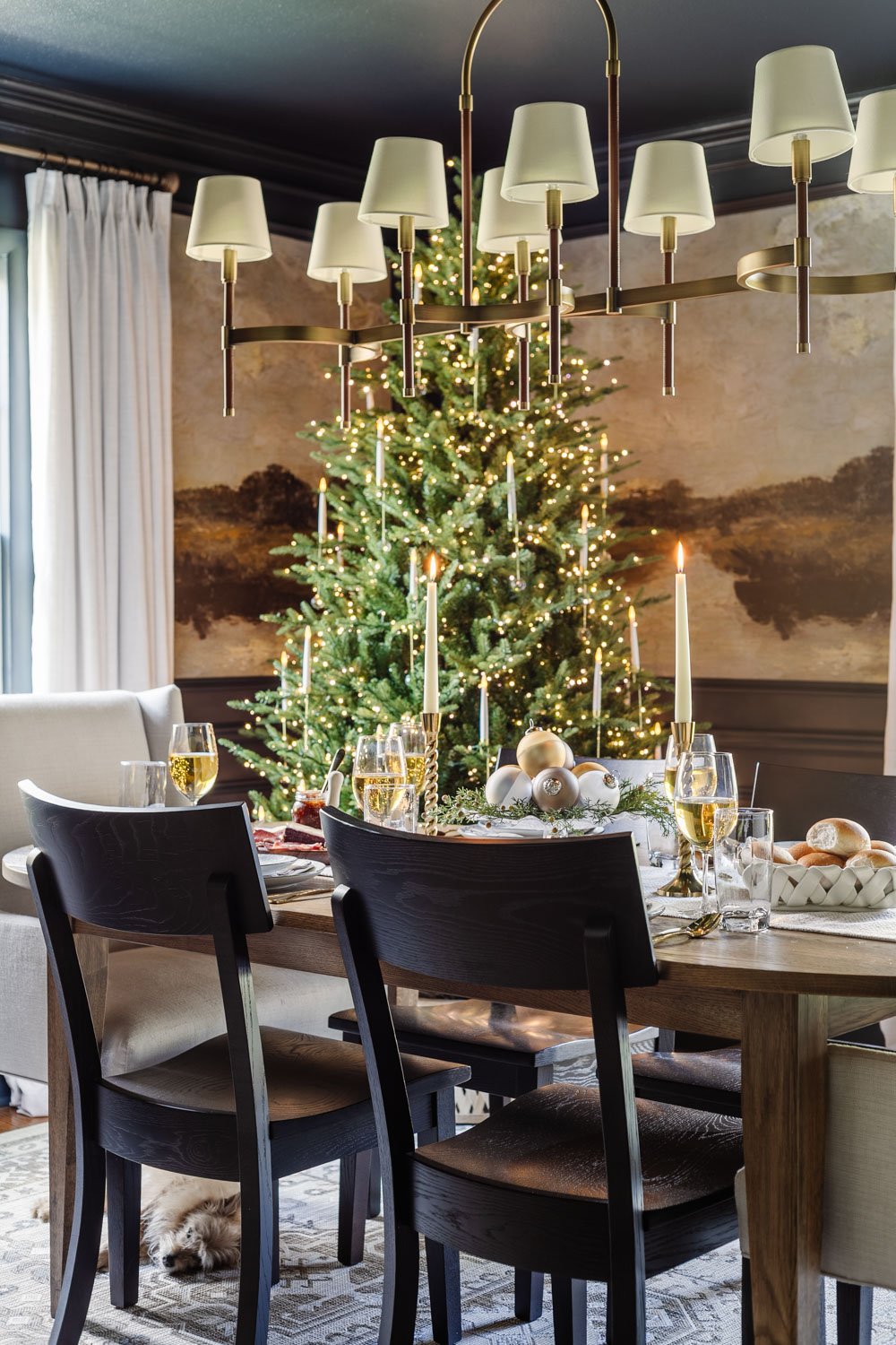 Christmas dining room decor with tree beside table