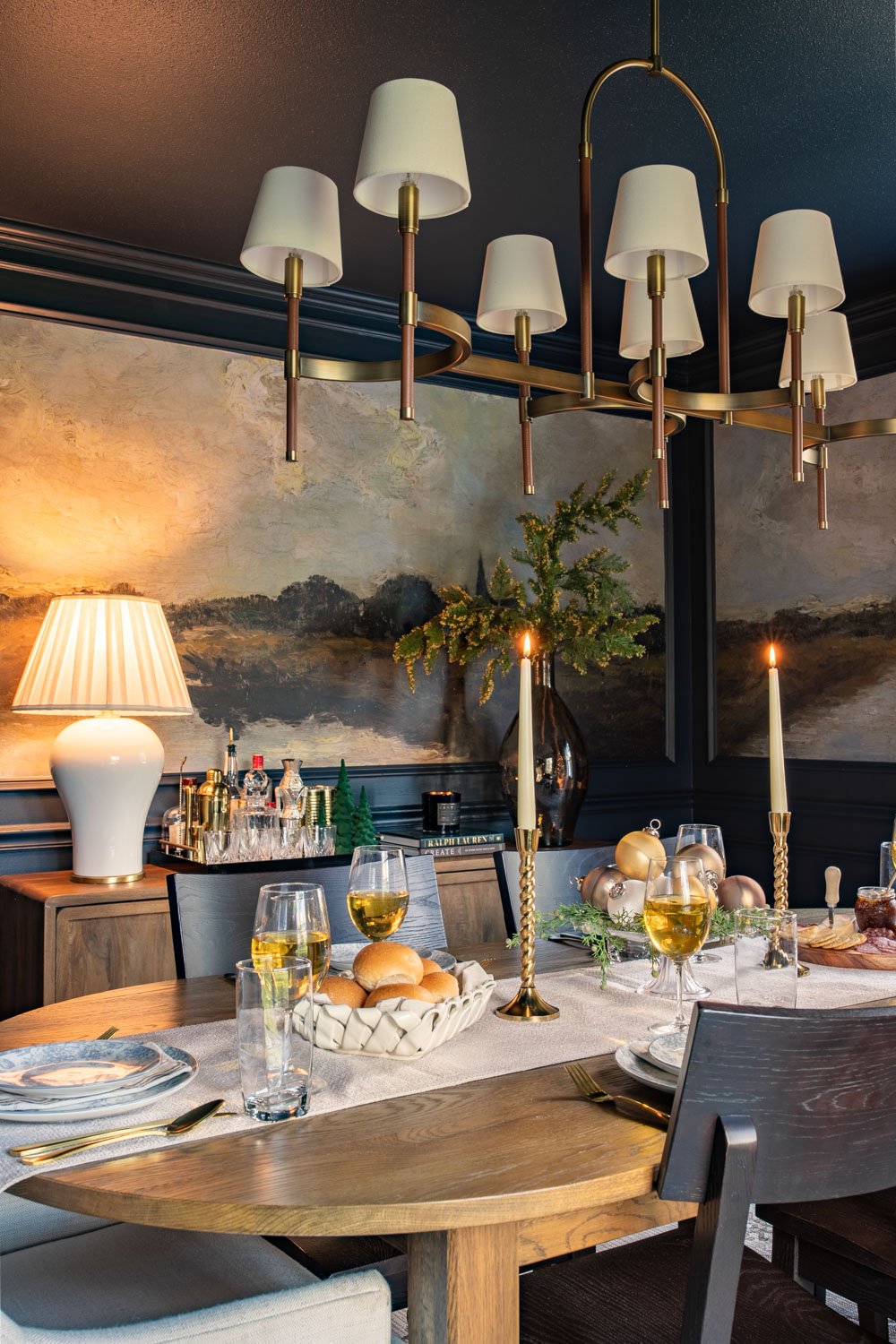 navy blue dining room decorated for Christmas with mural walls