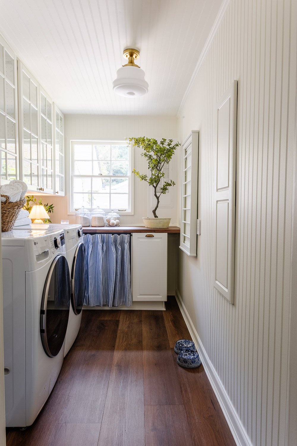 narrow laundry room layout with IKEA cabinets with vintage Nancy Meyers style