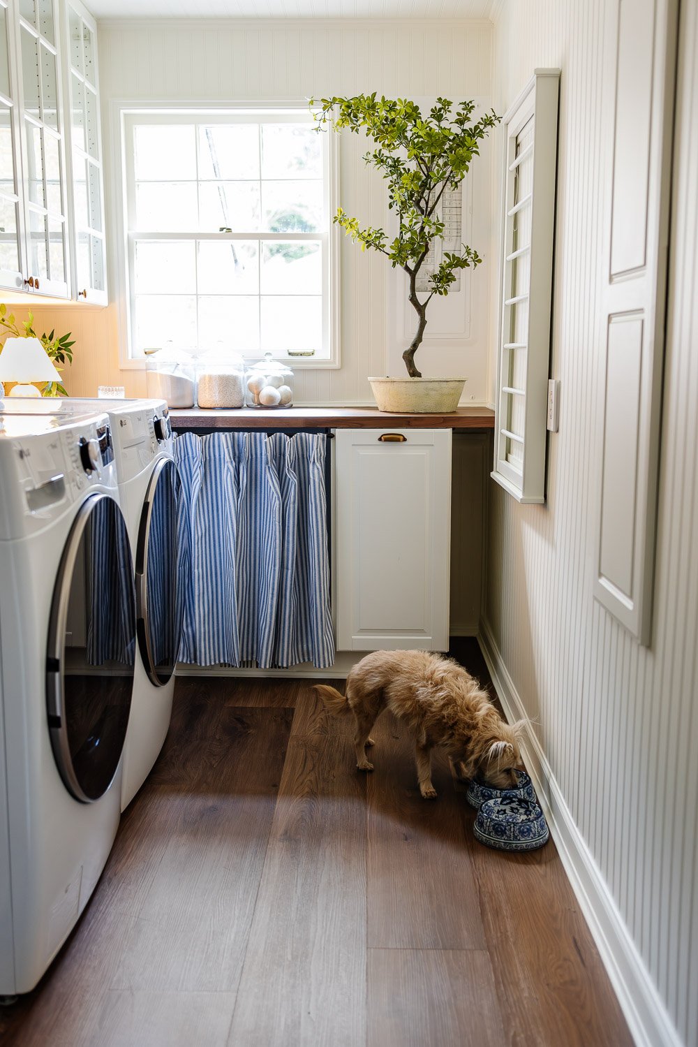 narrow laundry room layout with IKEA cabinets with vintage Nancy Meyers style