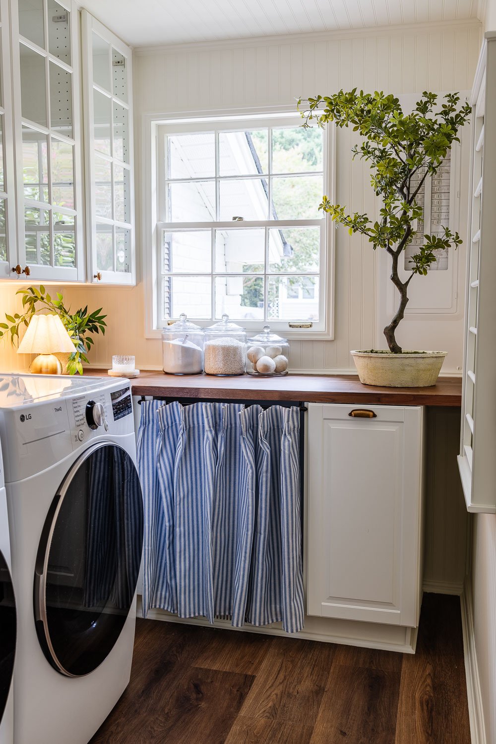 narrow laundry room layout with IKEA cabinets with vintage Nancy Meyers style
