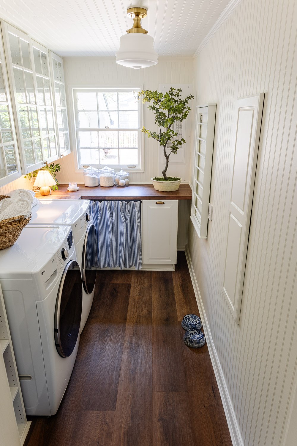 narrow laundry room layout with IKEA cabinets with vintage Nancy Meyers style