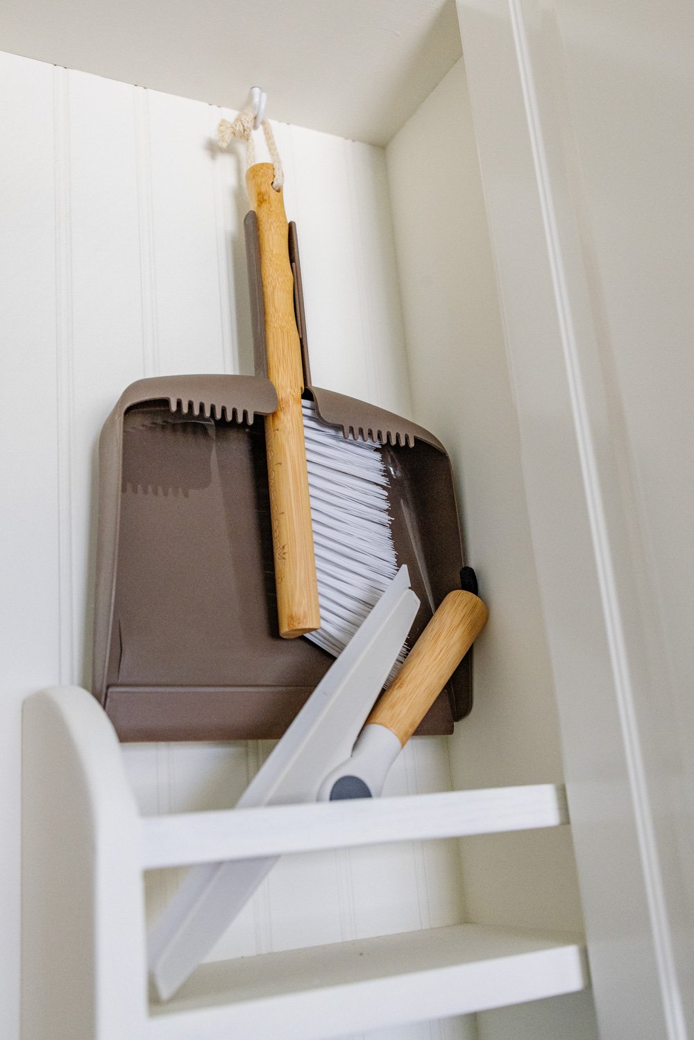 hidden diy broom cupboard and cleaning supply storage in a laundry room