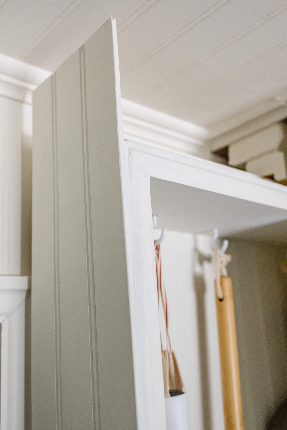 hidden diy broom cupboard and cleaning supply storage in a laundry room