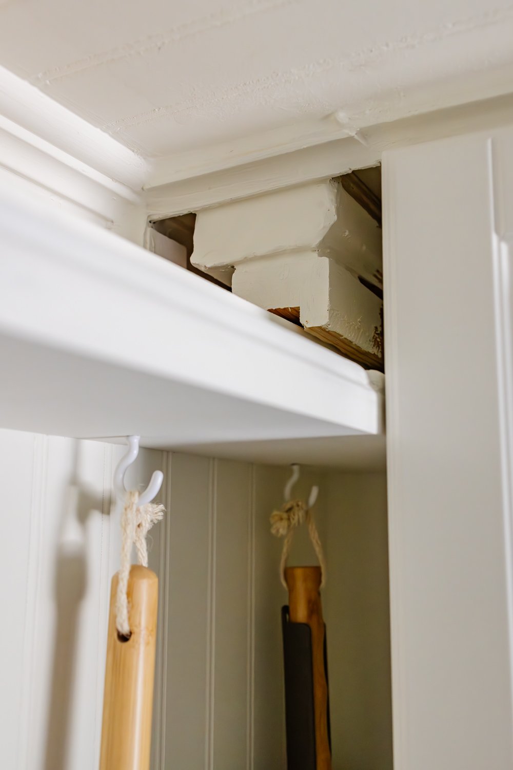 hidden diy broom cupboard and cleaning supply storage in a laundry room