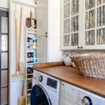 hidden diy broom cupboard and cleaning supply storage in a laundry room