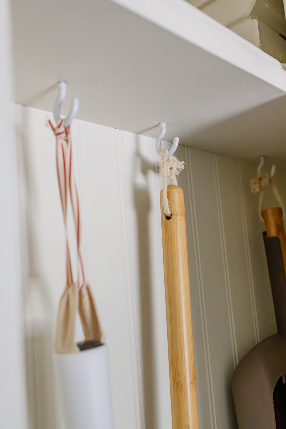 hidden diy broom cupboard and cleaning supply storage in a laundry room