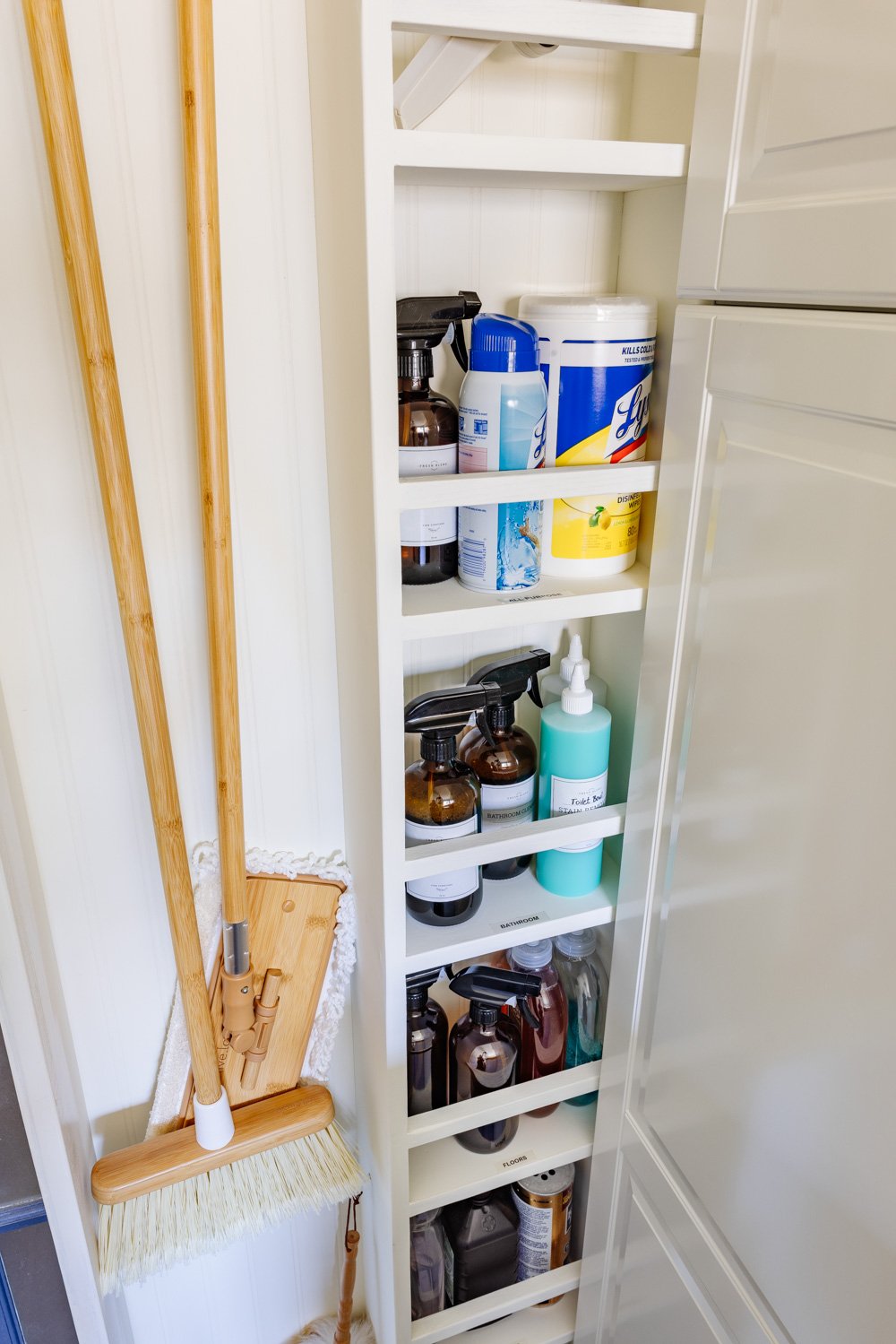 hidden diy broom cupboard and cleaning supply storage in a laundry room