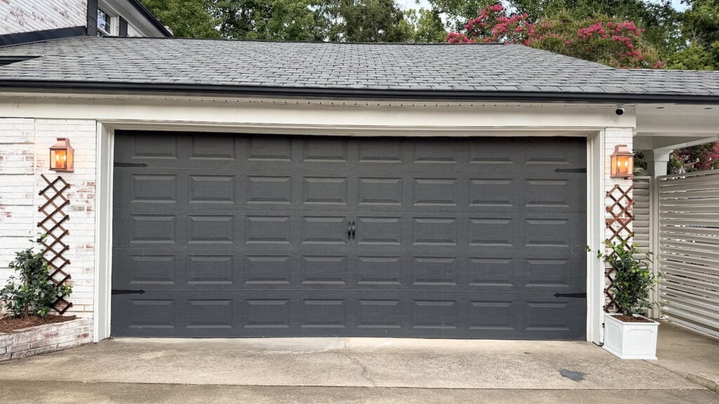 garage curb appeal with copper lanterns, star jasmine, and outdoor trash can hiding panels