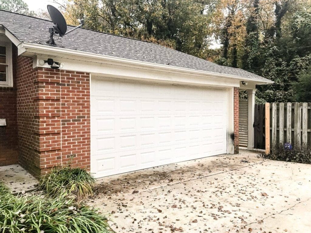 garage curb appeal with copper lanterns, star jasmine, and outdoor trash can hiding panels