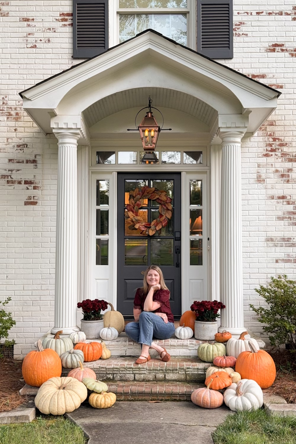 realistic fake pumpkins on limewashed brick porch steps