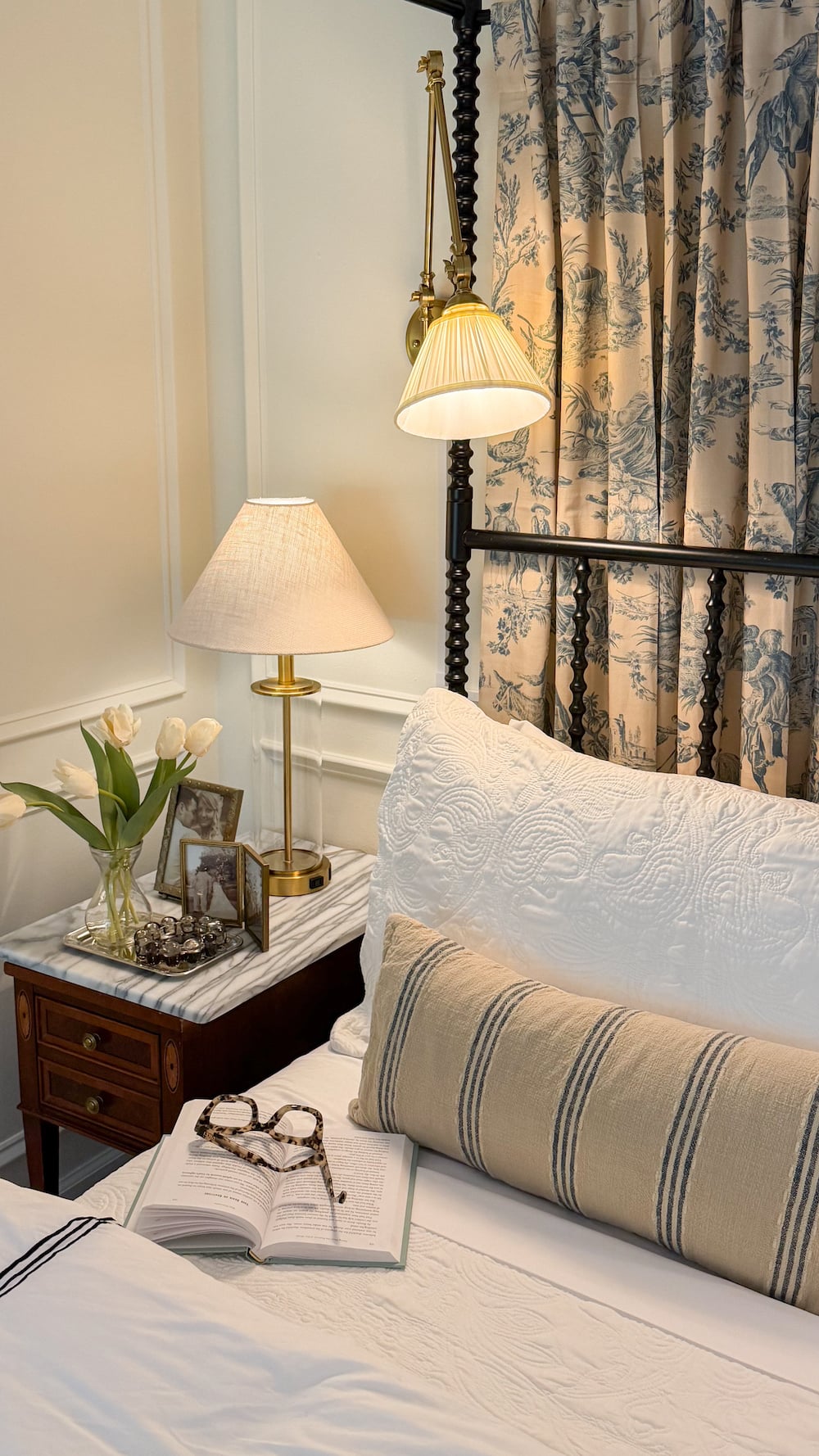 classic modern french country bedroom with layered lighting and canopy bed