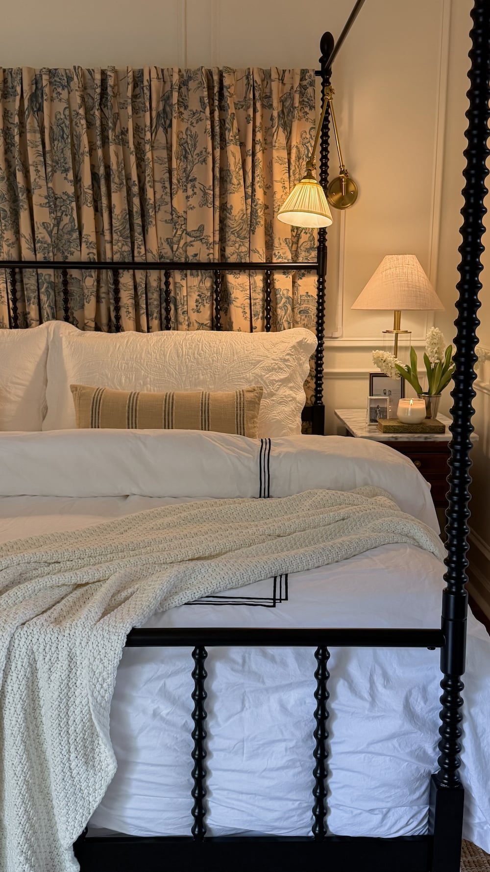classic modern french country bedroom with layered lighting and canopy bed