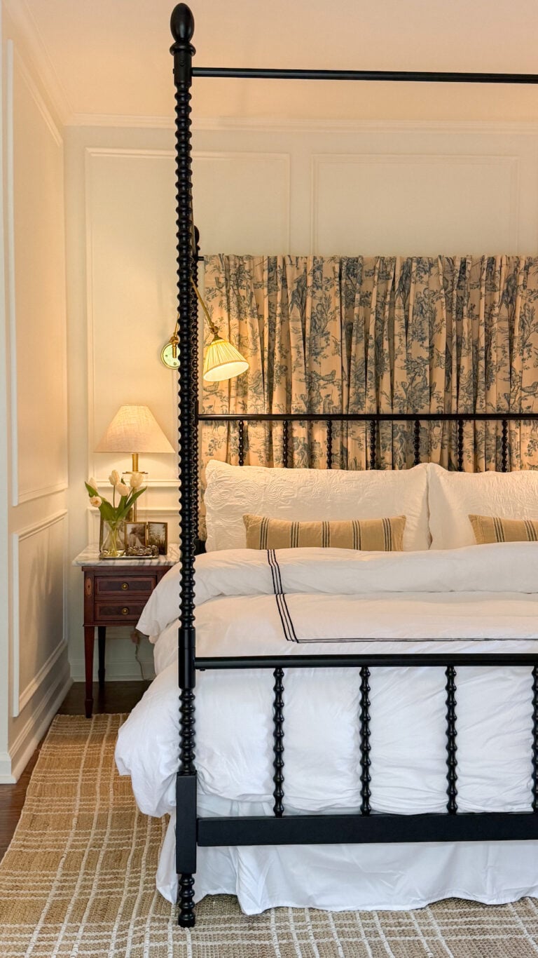 classic modern french country bedroom with layered lighting and canopy bed