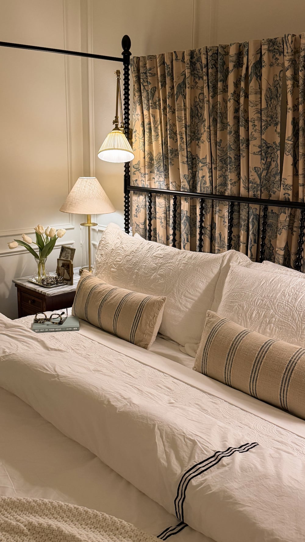 classic modern french country bedroom with layered lighting and canopy bed