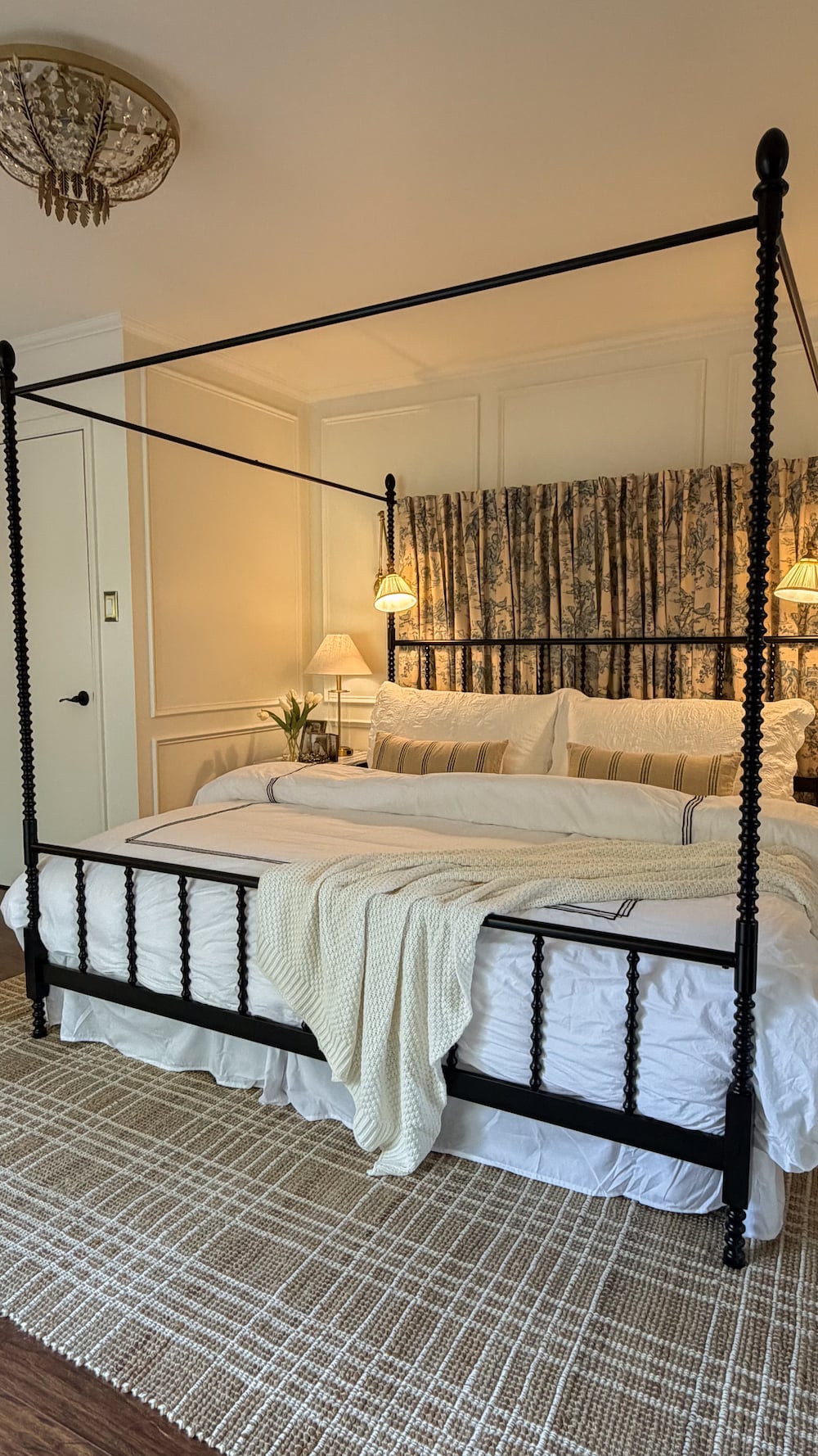 classic modern french country bedroom with layered lighting and canopy bed
