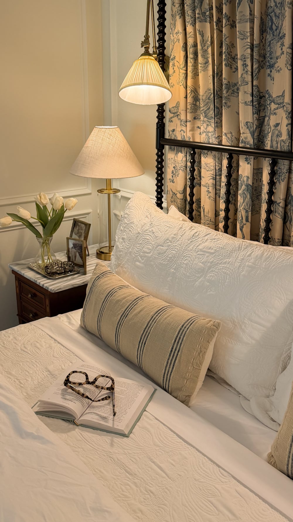 classic modern french country bedroom with layered lighting and canopy bed