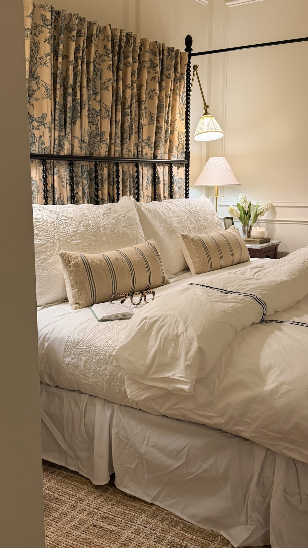 classic modern french country bedroom with layered lighting and canopy bed